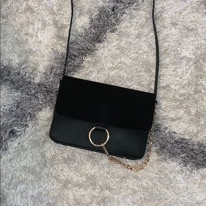Suade black crossbody with gold hardware